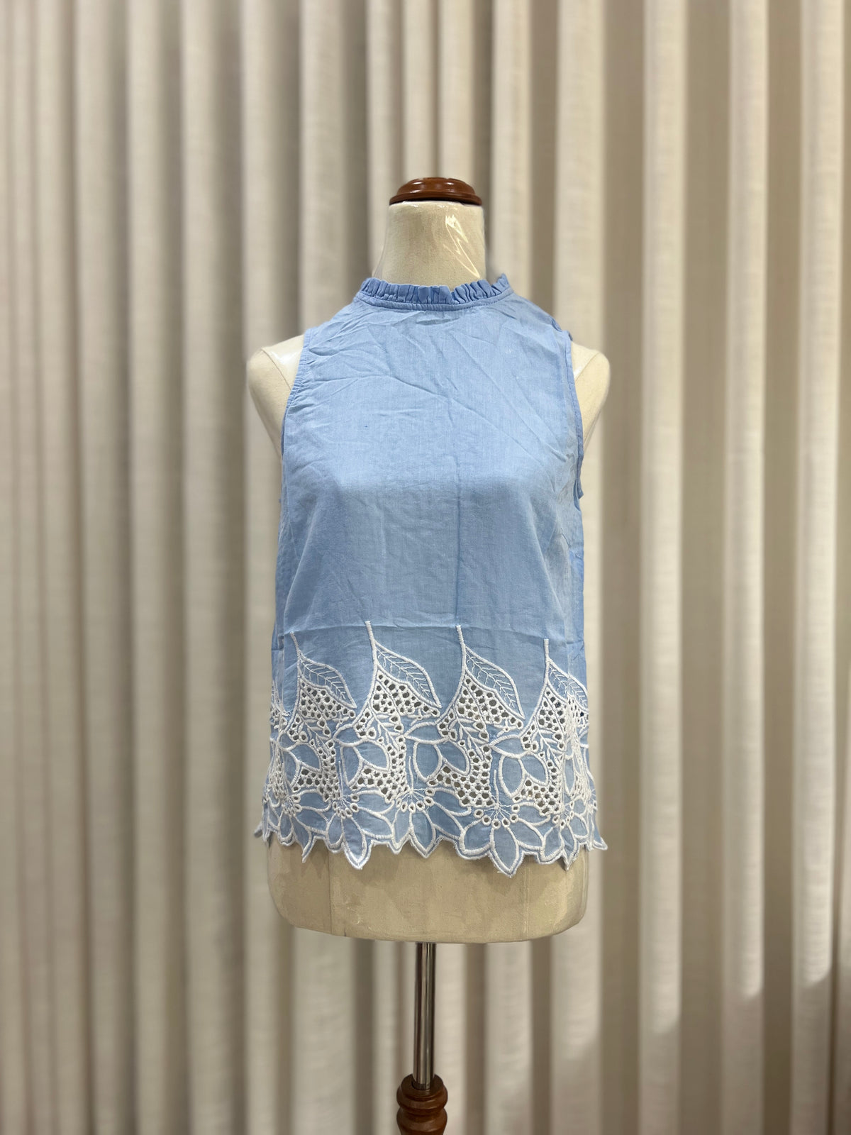 sleeveless blue and white embroided top